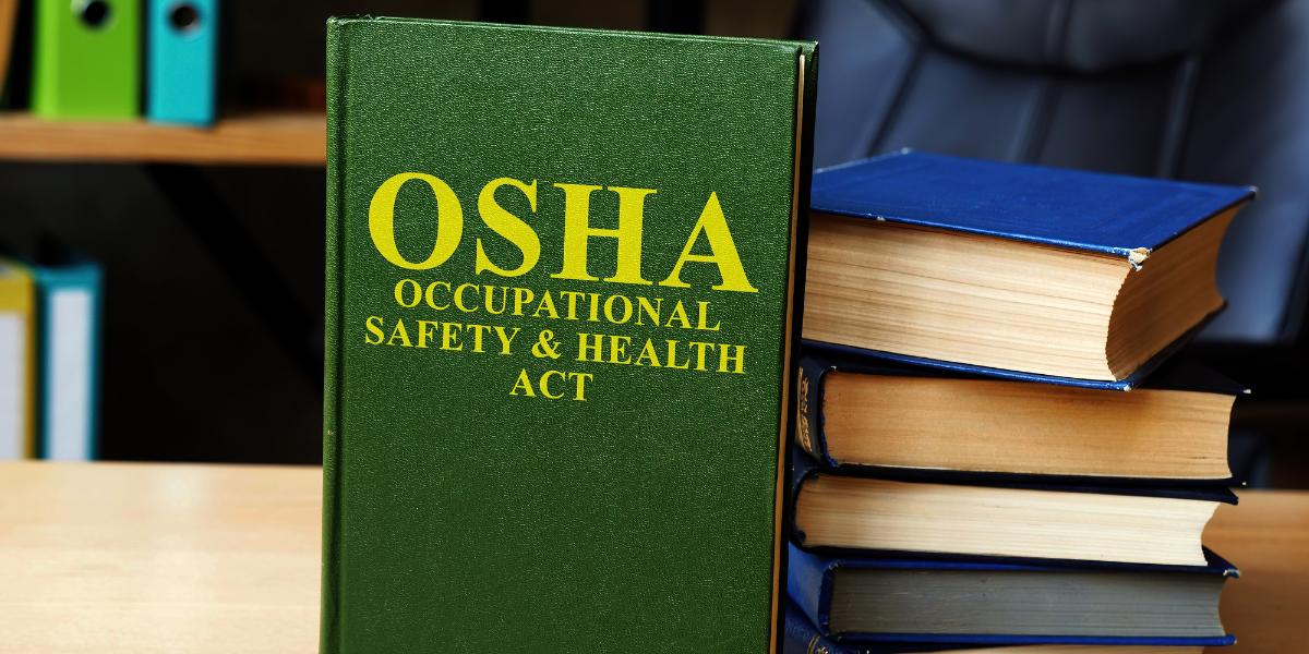 OSHA book laying next to a stack of important employment law books
