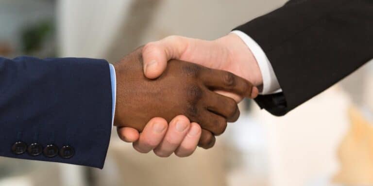 two men shaking hands over business partnership